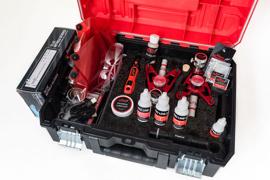 Open tool kit with various automotive tools and supplies on a white background