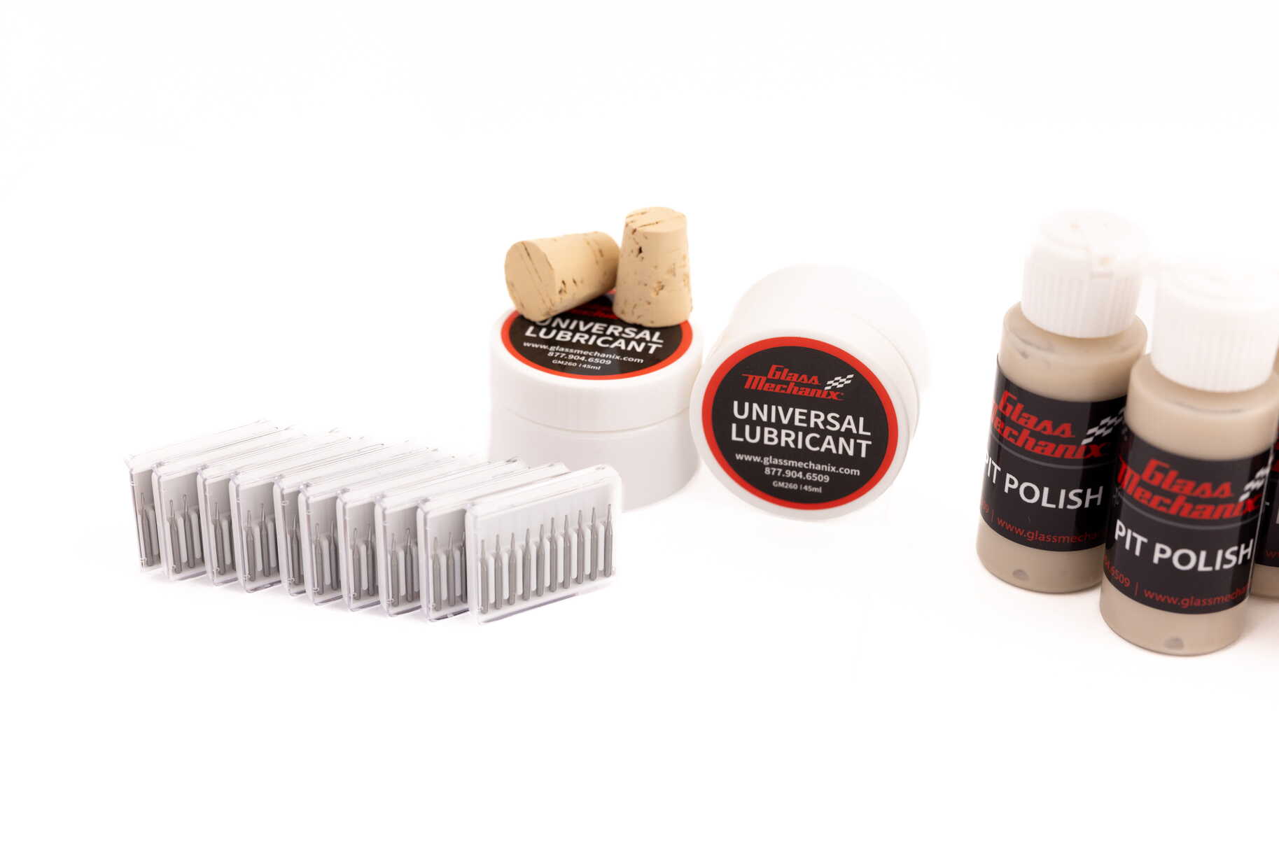 Glass Mechanix Enterprise Bulk Restock Pack close-up with tapered drill bits, universal lubricant, corks, and Pit Polish